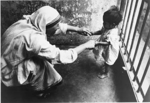 Mother Teresa playing with an abandoned child, Kolkata, 1960. American Catholic History Research Center and University Archives.